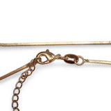 Lobster clasp on a box chain gold slinky anklet shown up close to show detail