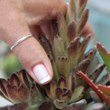 2mm Sterling Thumb Ring being worn on a thumb