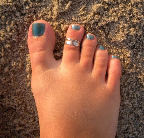 Braid Skinny and 3 mm flat band sterling Toe Rings on a foot in the sand