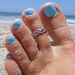 Celtic Weave Sterling Silver Toe Ring shown on a foot at the beach