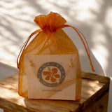 Pearl bracelet in a bright orange organza gift bag.