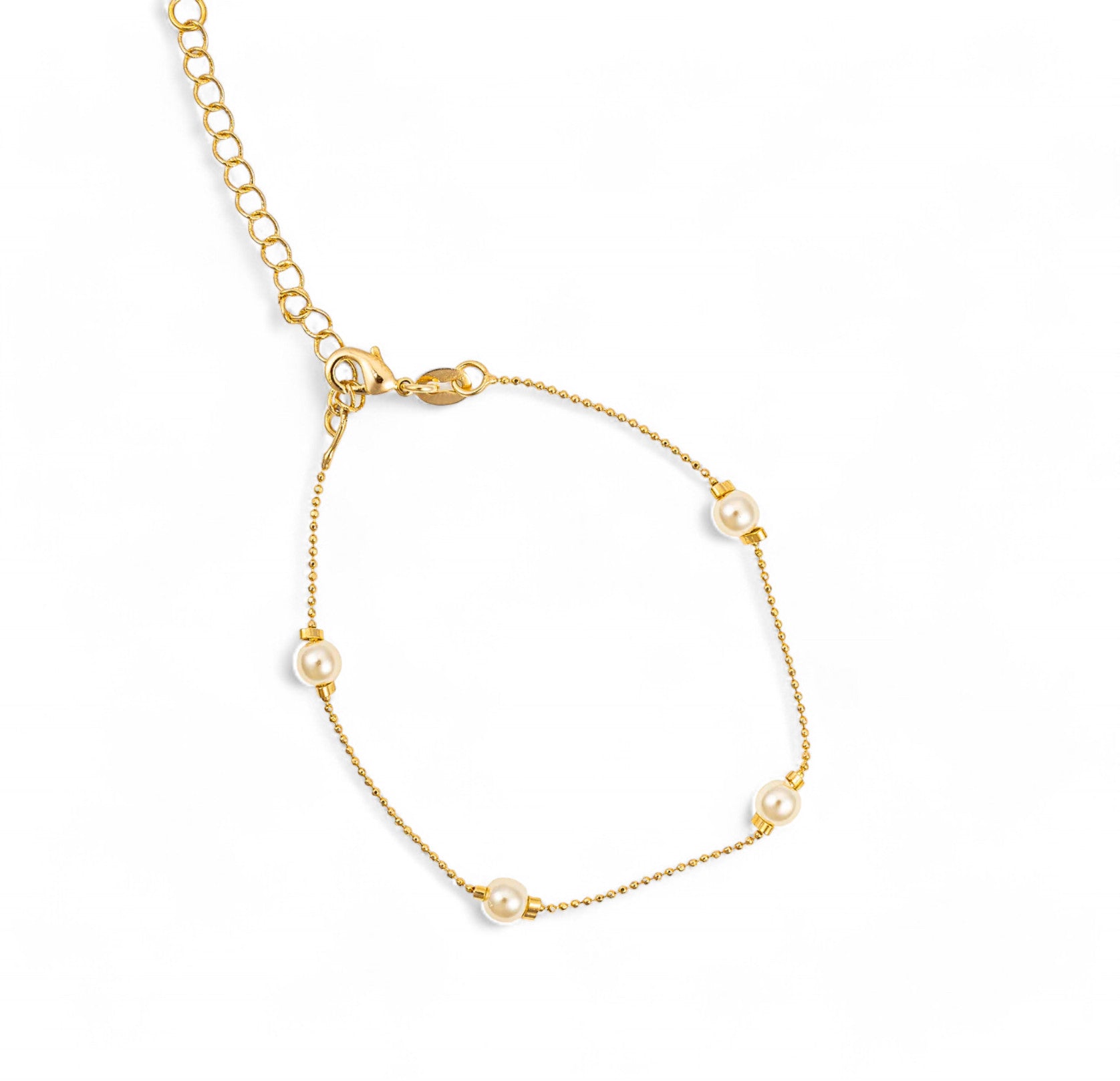 Gold small bead chain bracelet with pearl accents. 7" in length and 2" lead chain for sizing. 