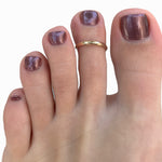 Shown here on a foot, 1mm Simple Band Adjustable Toe Ring for Men and Women One Size Fits All (c) 2022