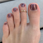 A 2mm Gold Fill Adjustable Toe Ring shown on an index toe