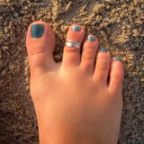 Braid Skinny and 3 mm flat band sterling Toe Rings on a foot in the sand