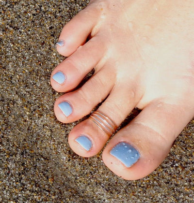 Four Strand Sterling & Gold Fill Toe Ring shown on a toe in the sand