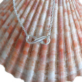 Infinity Charm Sterling Anklet displayed on a sea shell