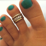 3mm Gold Fill Toe Ring shown in a stack together with bee bee and braid toe rings