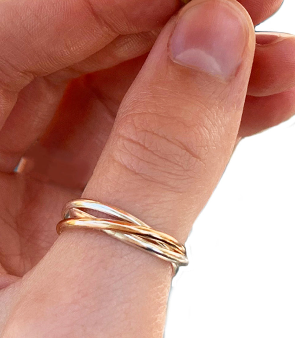 Rolling Interlock Sterling and Gold Fill Thumb Ring shown worn on a thumb