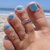 Celtic Weave Sterling Silver Toe Ring shown on a foot at the beach